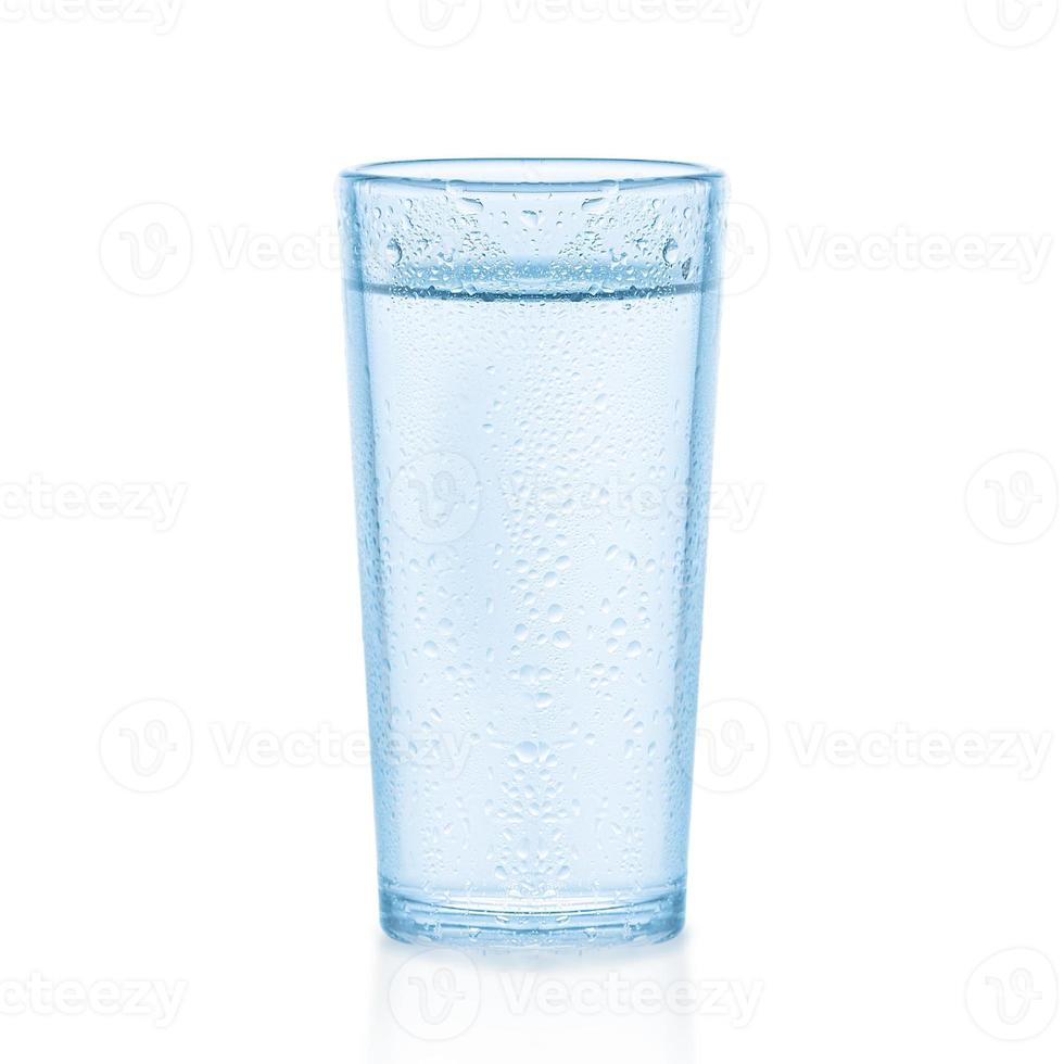 Glass of Water isolated on a white background. On the table drops water. photo