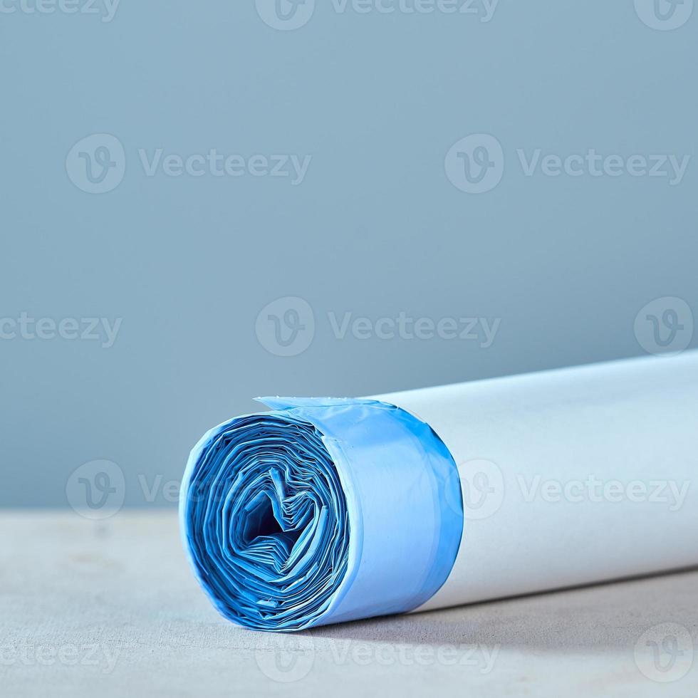 Roll of blue garbage bags. The concept of cleaning. photo