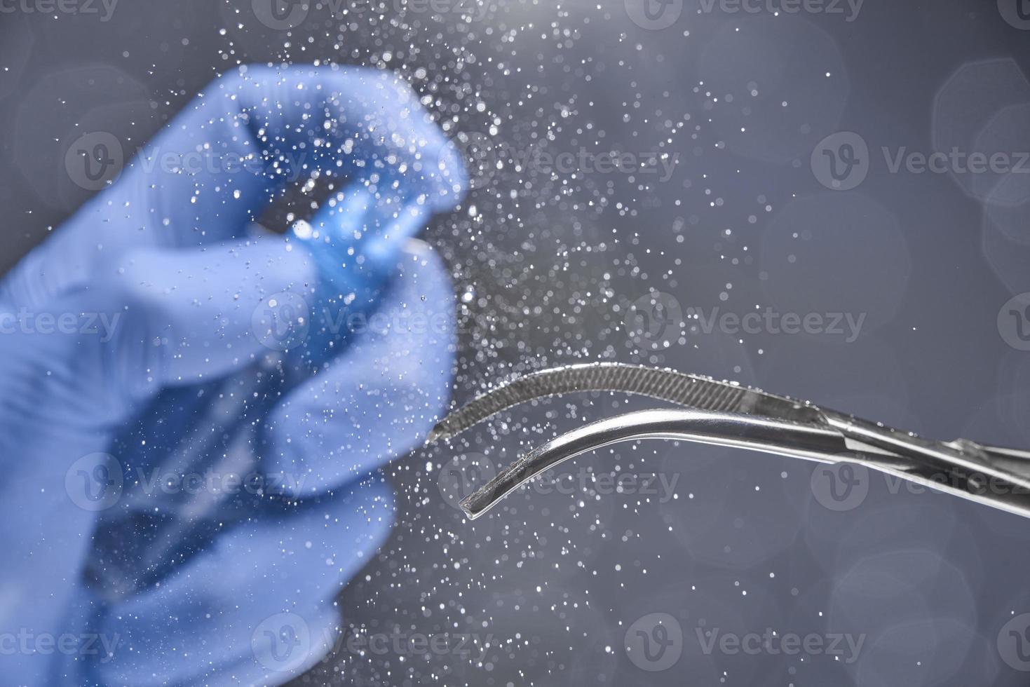 Disinfection of surgical instruments on a grey background. photo