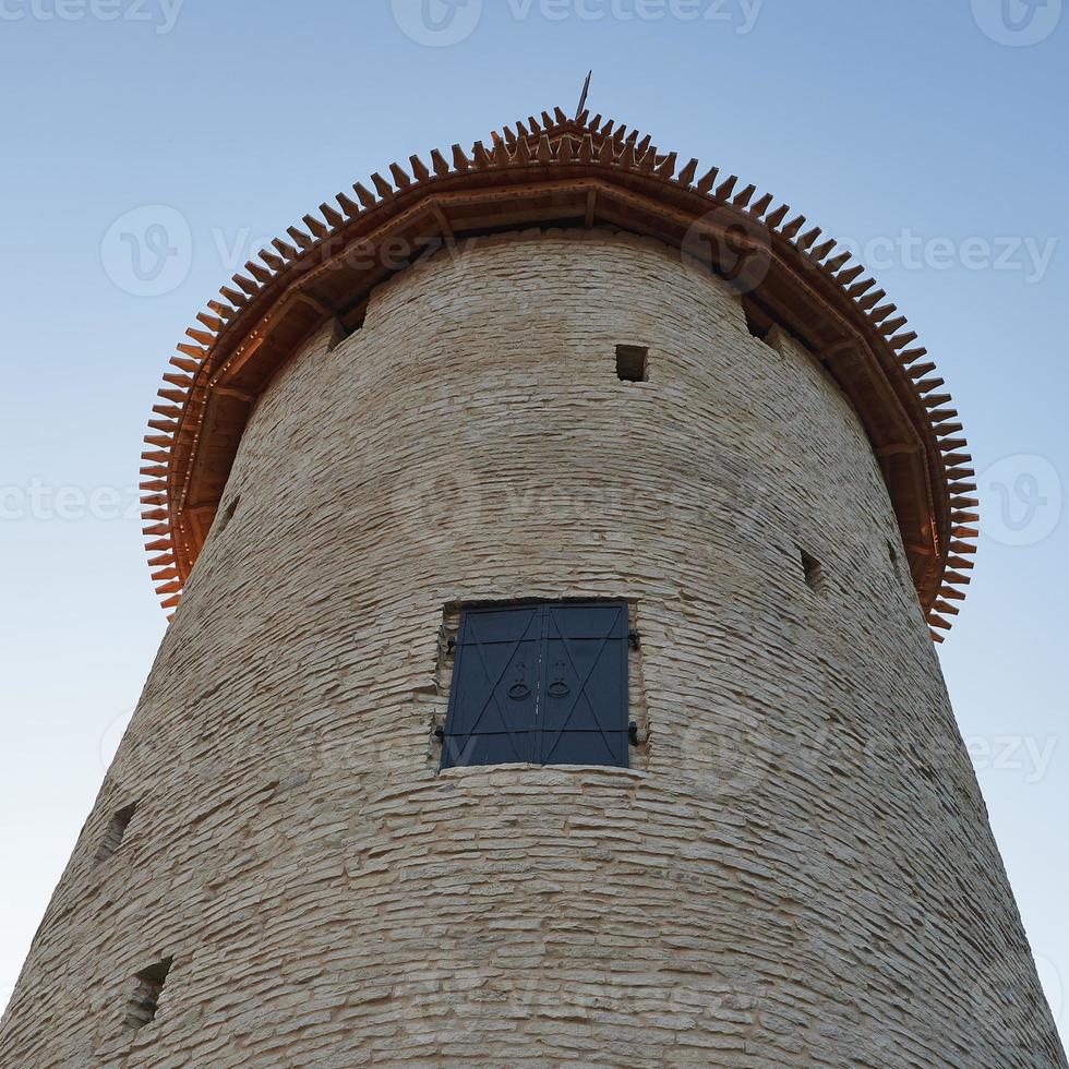 High tower of the Pskov Kremlin against the blue sky. Bottom view. photo