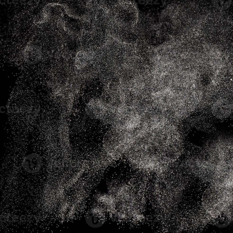 Movement of flying powder on a black background. photo