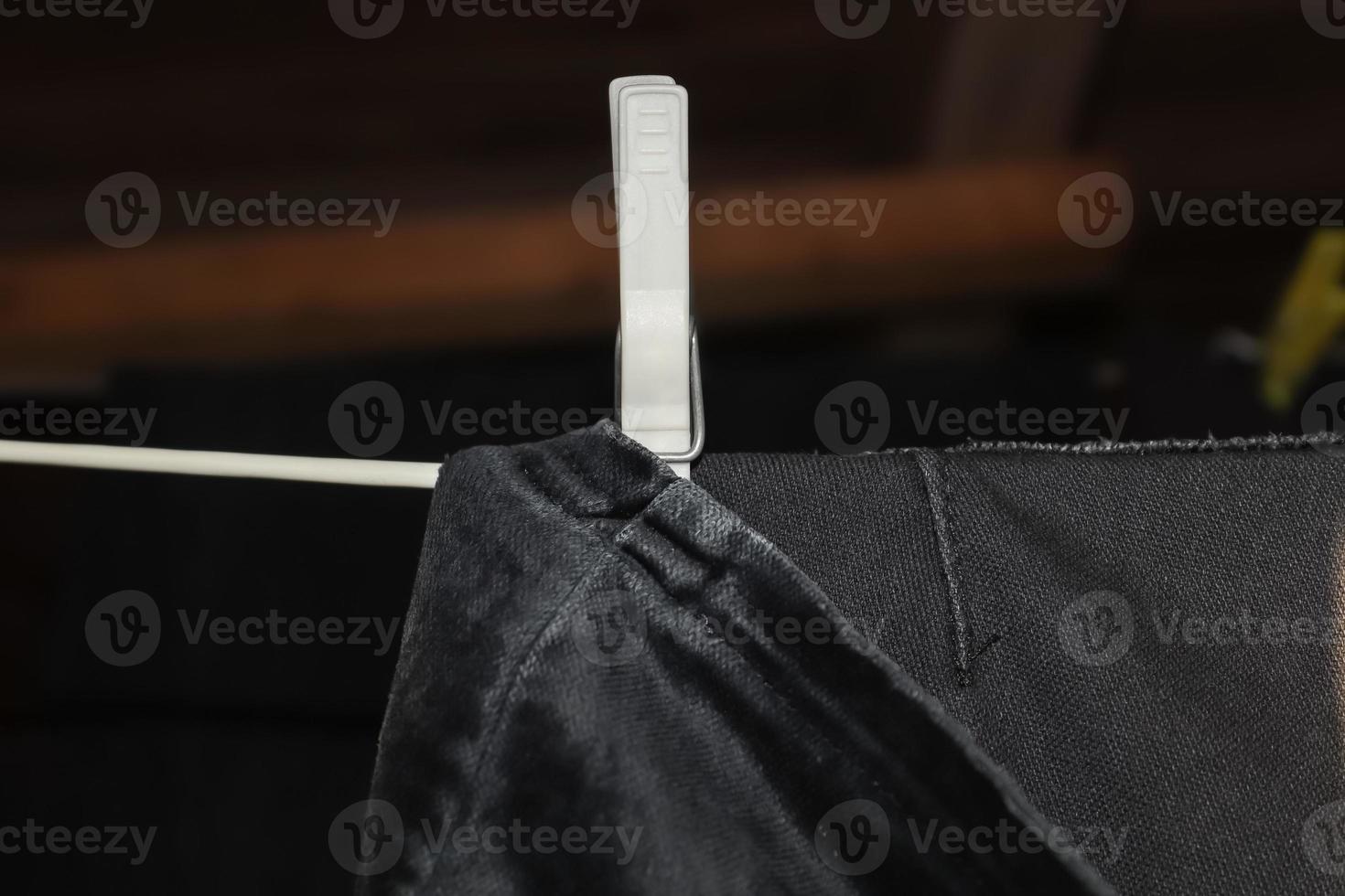 Clothes hung out to dry on a washing line and fastened by the clothes pegs photo