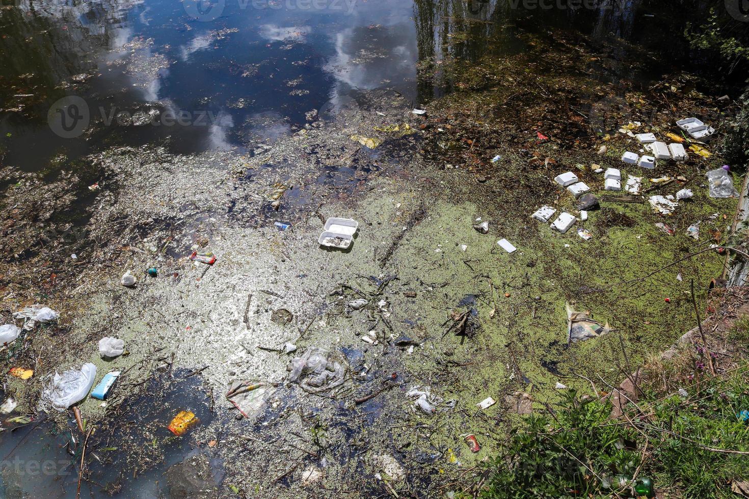 Environmental pollution found at a lake where people dumped their rubbish. photo