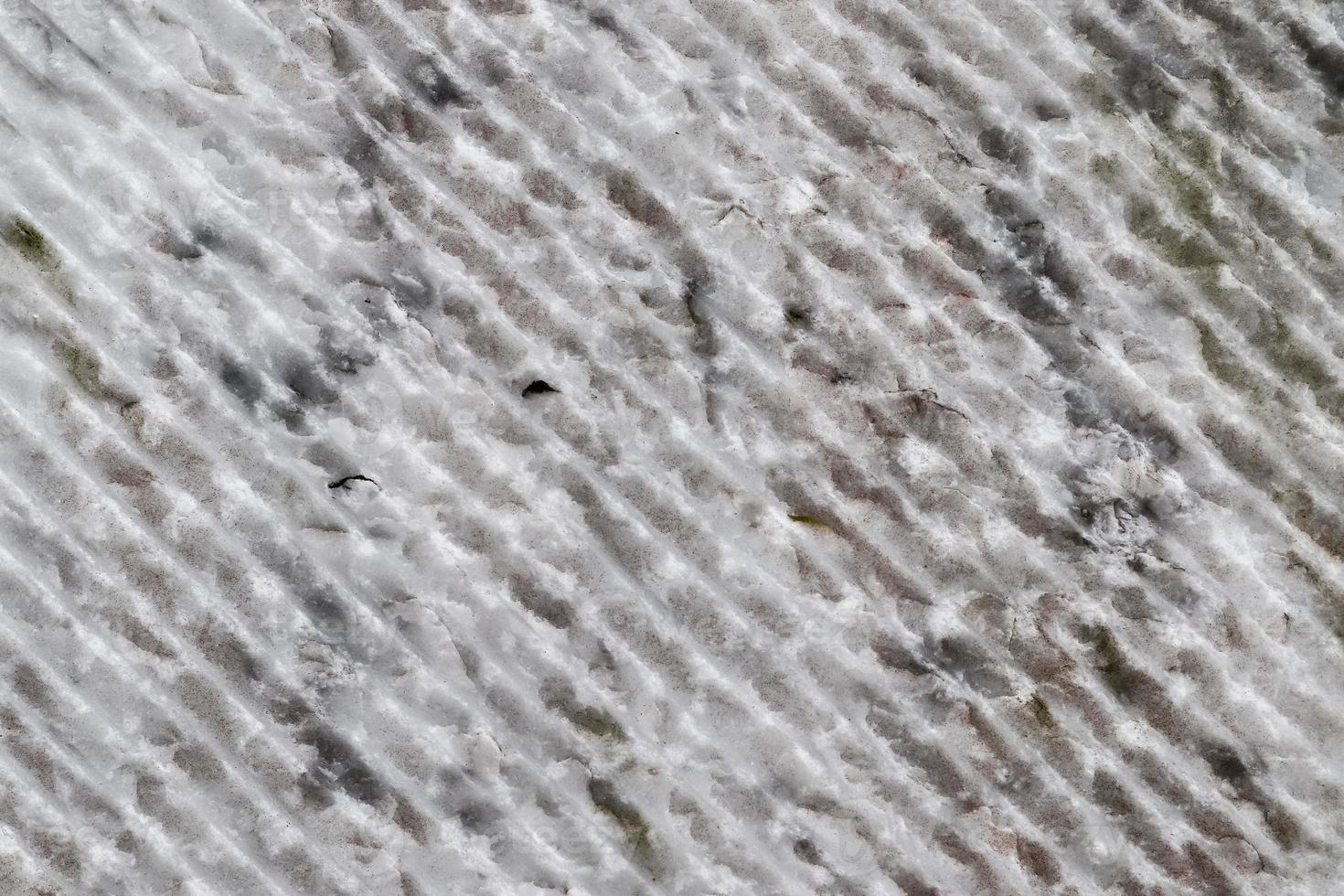Close up view at the surface of a white marble stone. photo