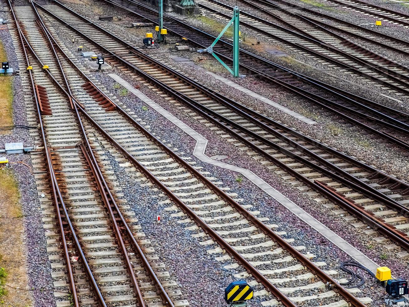 Multiple railroad tracks with junctions at a railway station in a perspective and birds view photo
