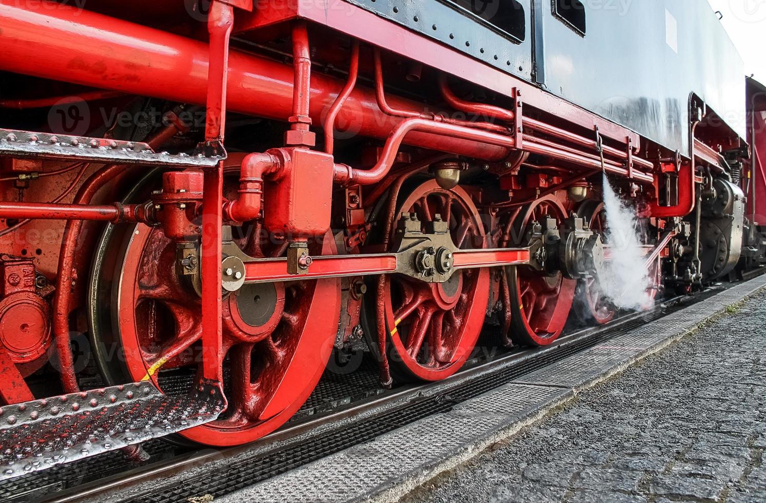 Old steam locomotive in black and red photo