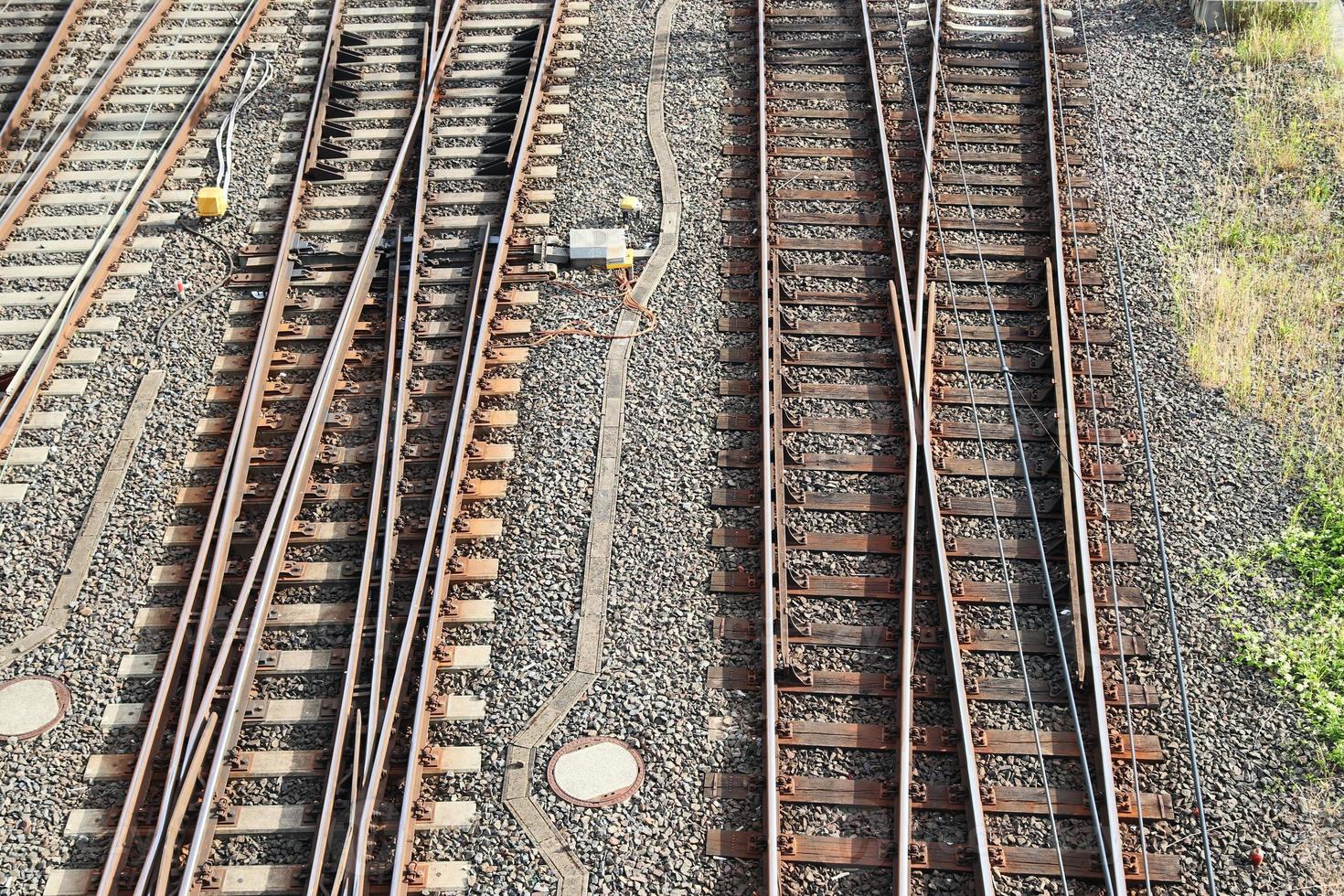 Multiple railroad tracks with junctions at a railway station in a perspective and birds view photo