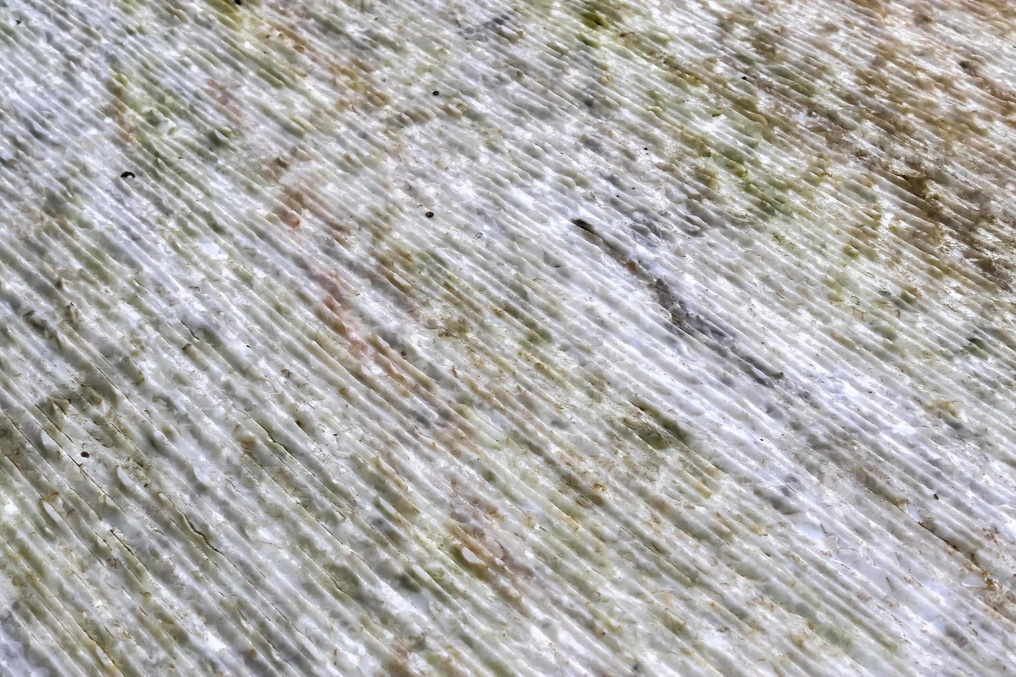 Close up view at the surface of a white marble stone. photo