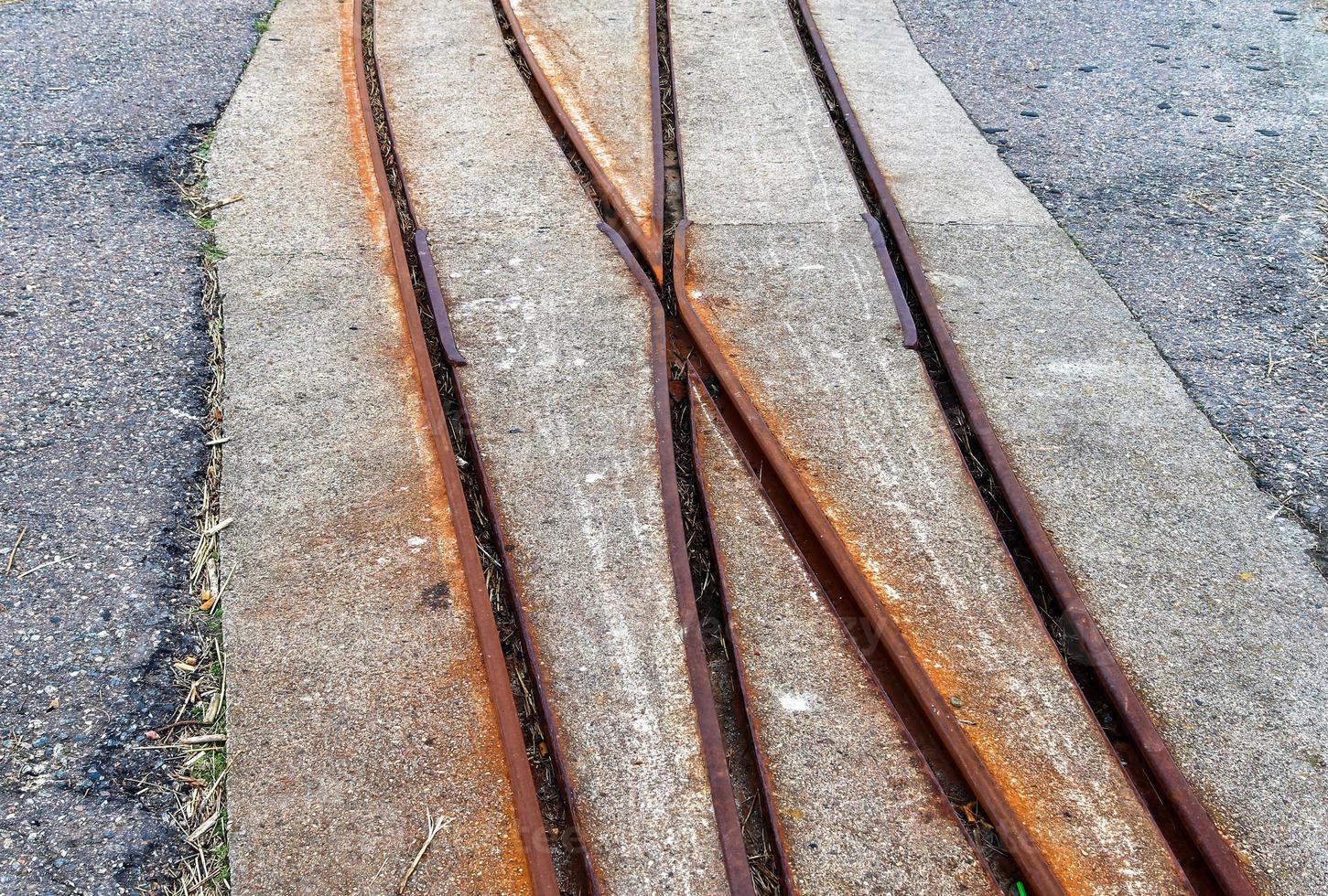 Multiple railroad tracks with junctions at a railway station in a perspective and birds view photo