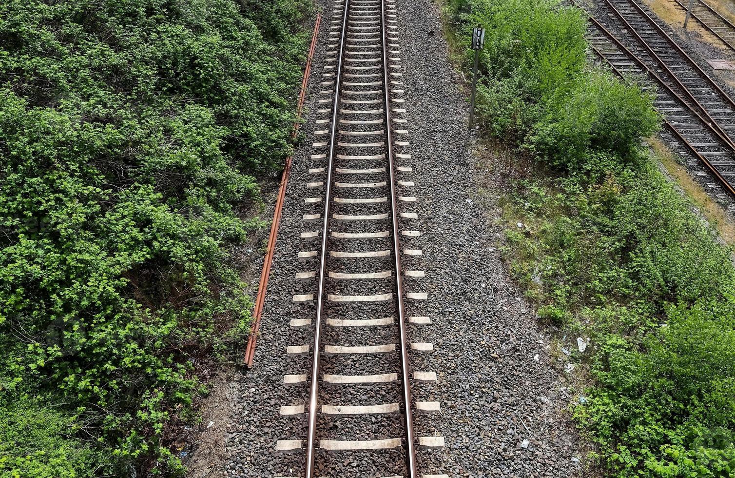 Multiple railroad tracks with junctions at a railway station in a perspective and birds view photo