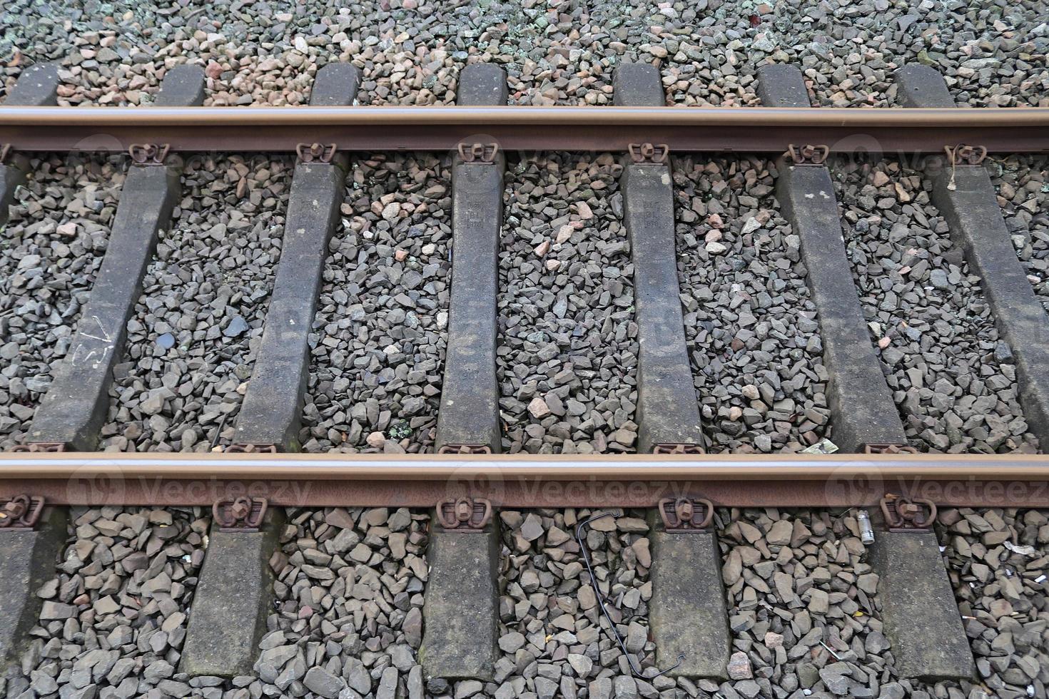 Multiple railroad tracks with junctions at a railway station in a perspective and birds view photo