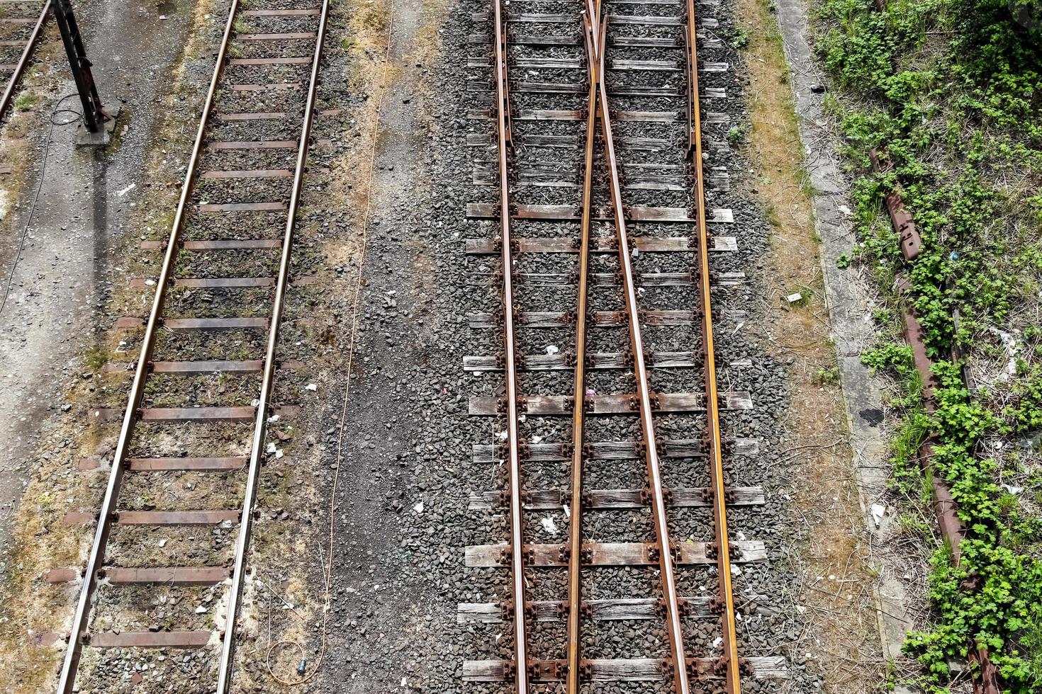 Multiple railroad tracks with junctions at a railway station in a perspective and birds view photo