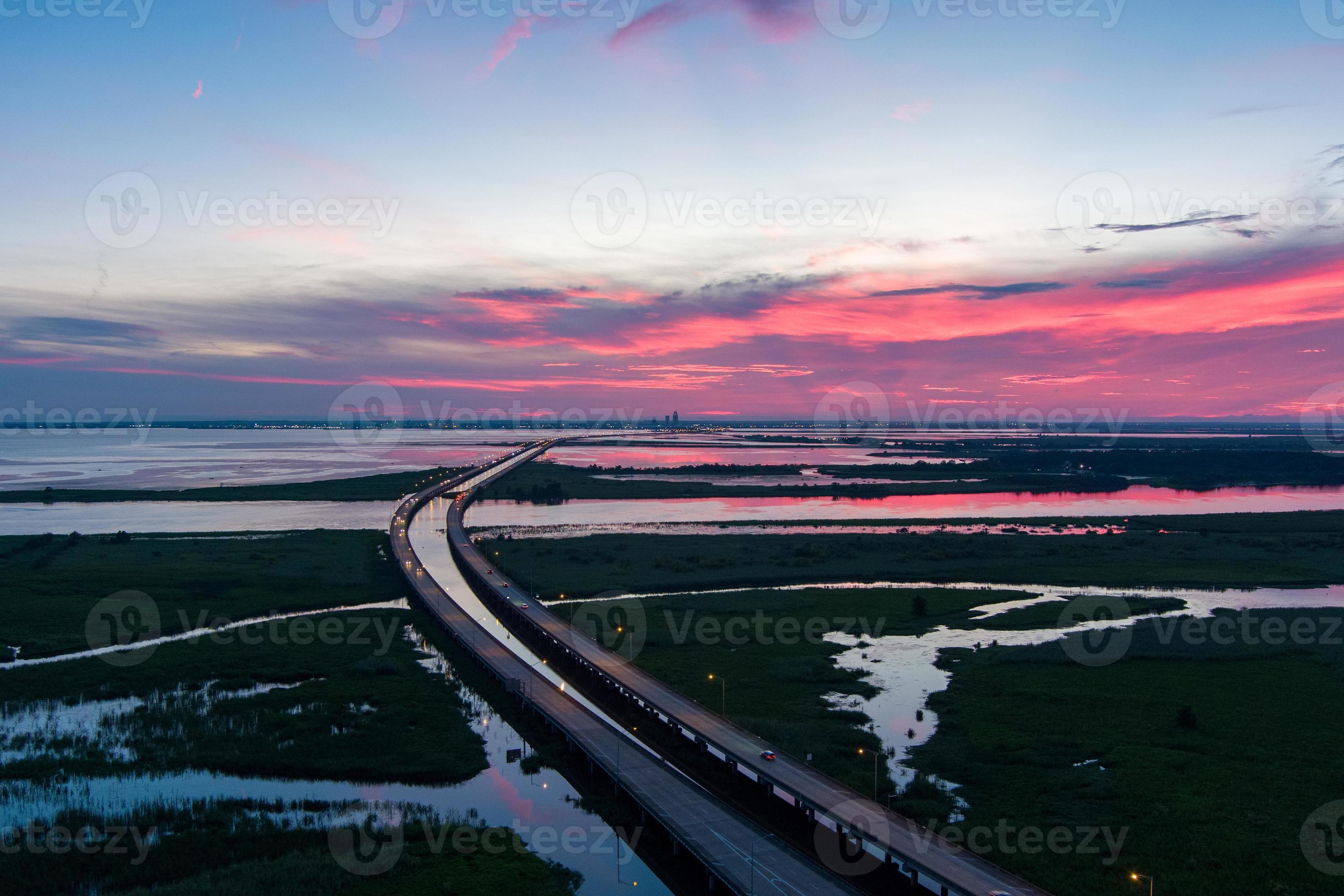 Aerial view of Mobile Bay and Jubilee Parkway bridge at sunset on the