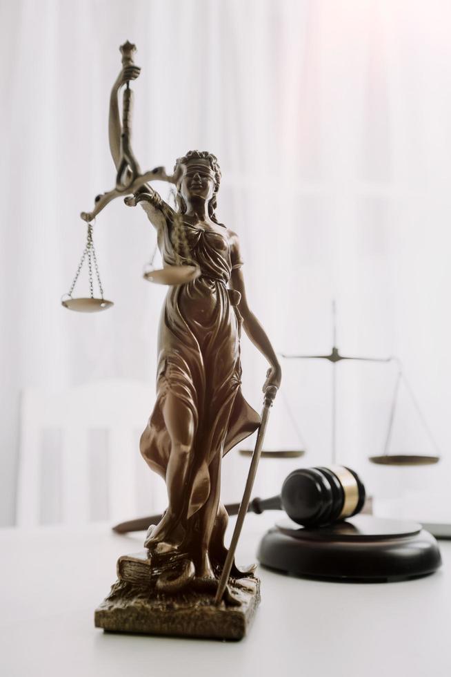 Business and lawyers discussing contract papers with brass scale on desk in office. Law, legal services, advice, justice and law concept picture with film grain effect photo