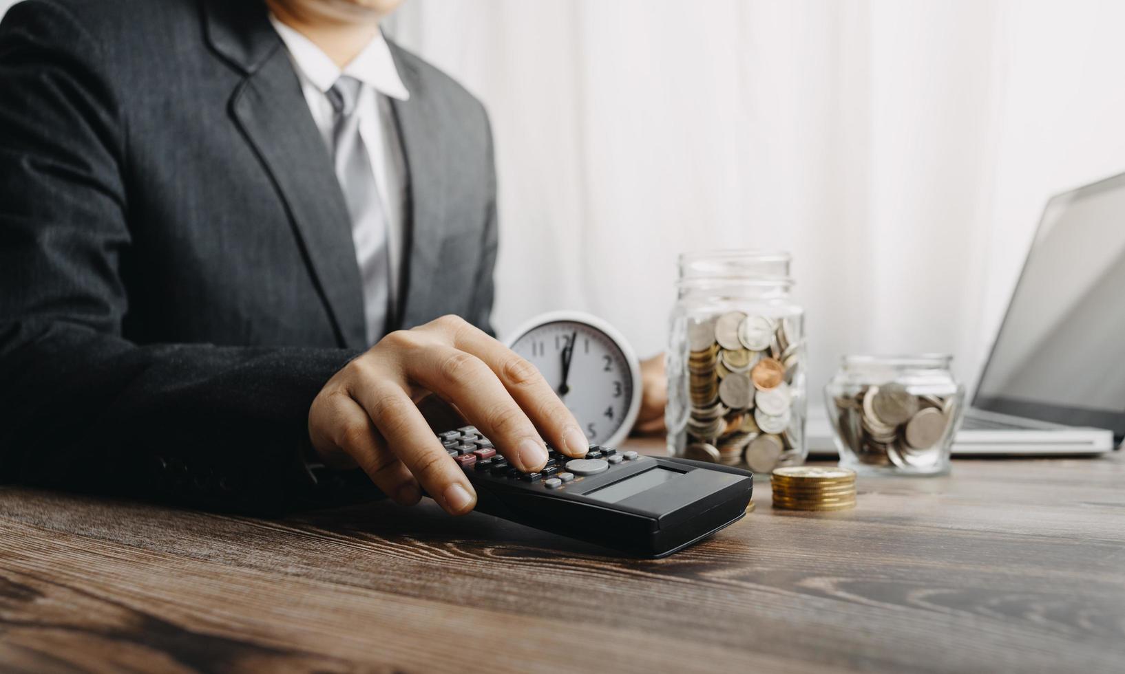 Business accounting concept, Business man using calculator with computer laptop, budget and loan paper in office. photo