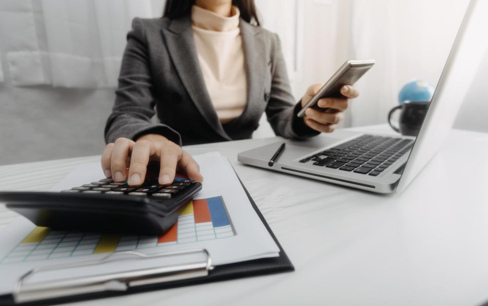 Business accounting concept, Business man using calculator with computer laptop, budget and loan paper in office. photo