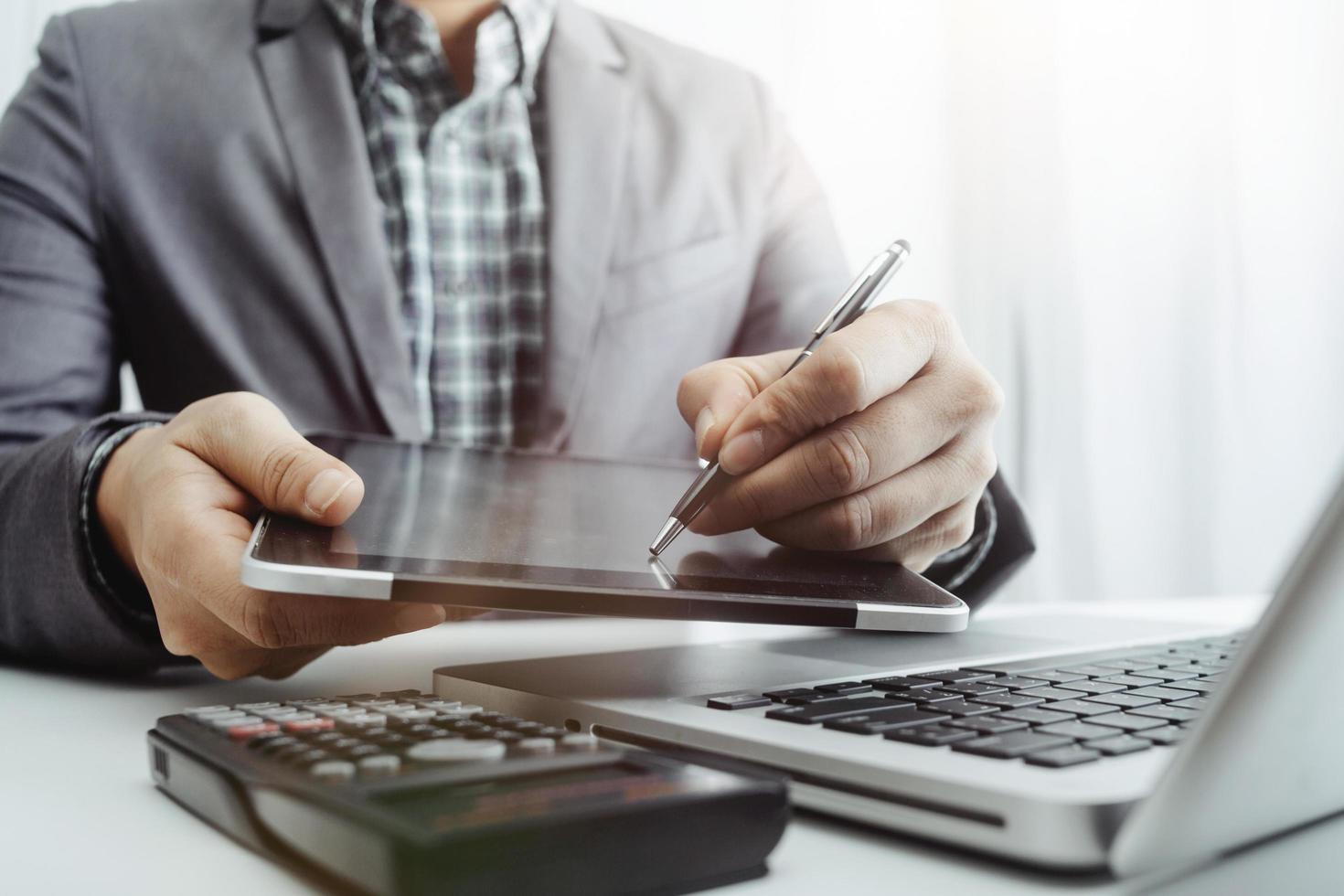 Business accounting concept, Business man using calculator with computer laptop, budget and loan paper in office. photo