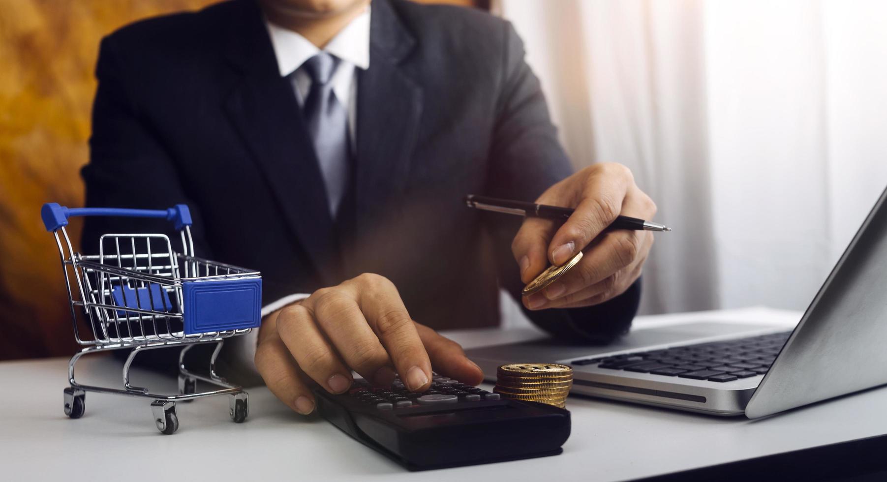 Business accounting concept, Business man using calculator with computer laptop, budget and loan paper in office. photo