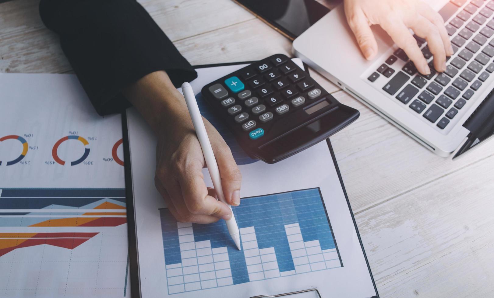 Business accounting concept, Business man using calculator with computer laptop, budget and loan paper in office. photo