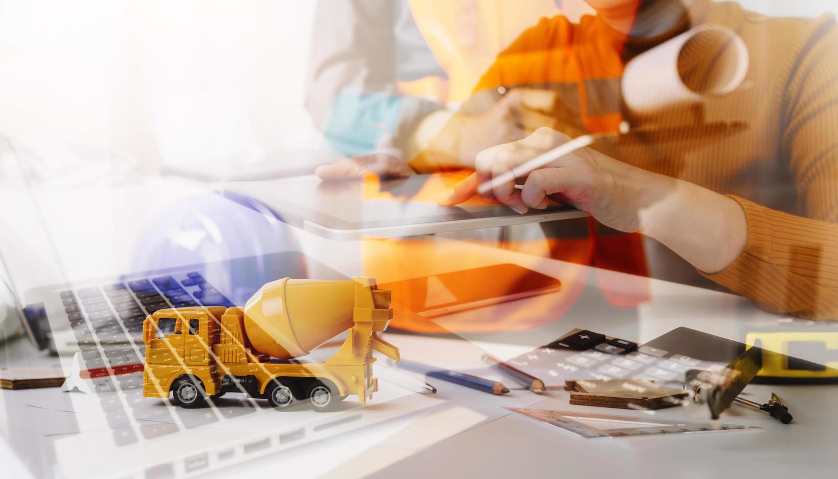 business hand working and laptop with on on architectural project at construction site at office desk in office photo