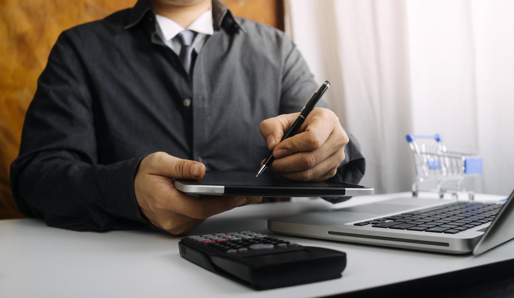 Business accounting concept, Business man using calculator with computer laptop, budget and loan paper in office. photo