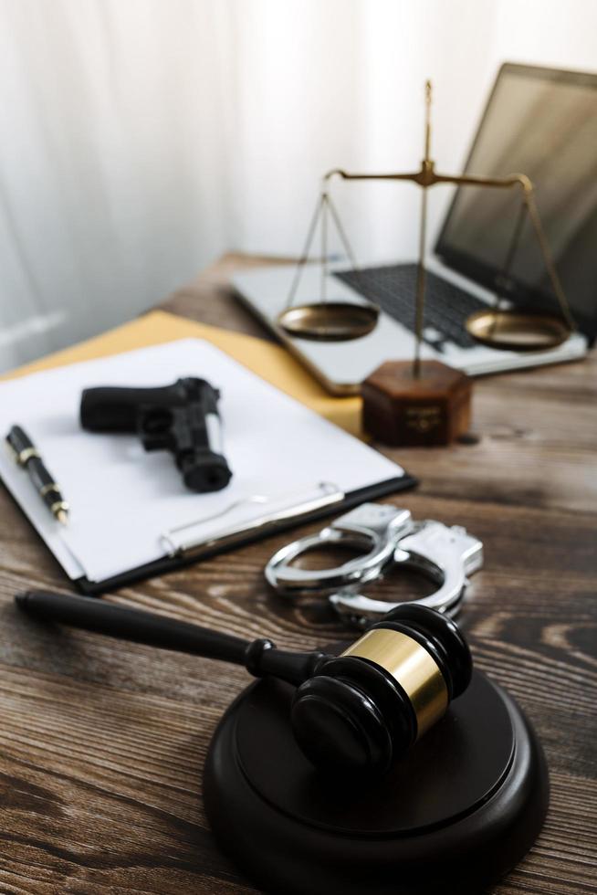 Business and lawyers discussing contract papers with brass scale on desk in office. Law, legal services, advice, justice and law concept picture with film grain effect photo