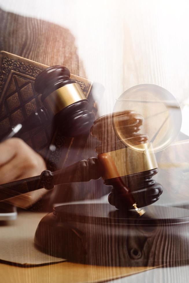 Business and lawyers discussing contract papers with brass scale on desk in office. Law, legal services, advice, justice and law concept picture with film grain effect photo