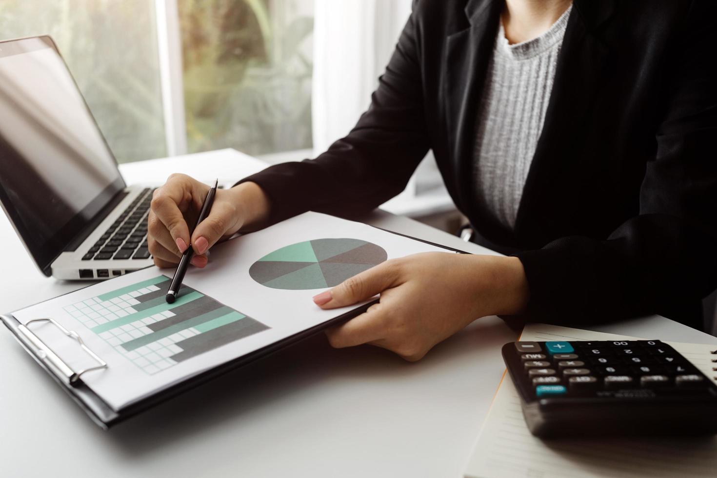 Business accounting concept, Business man using calculator with computer laptop, budget and loan paper in office. photo