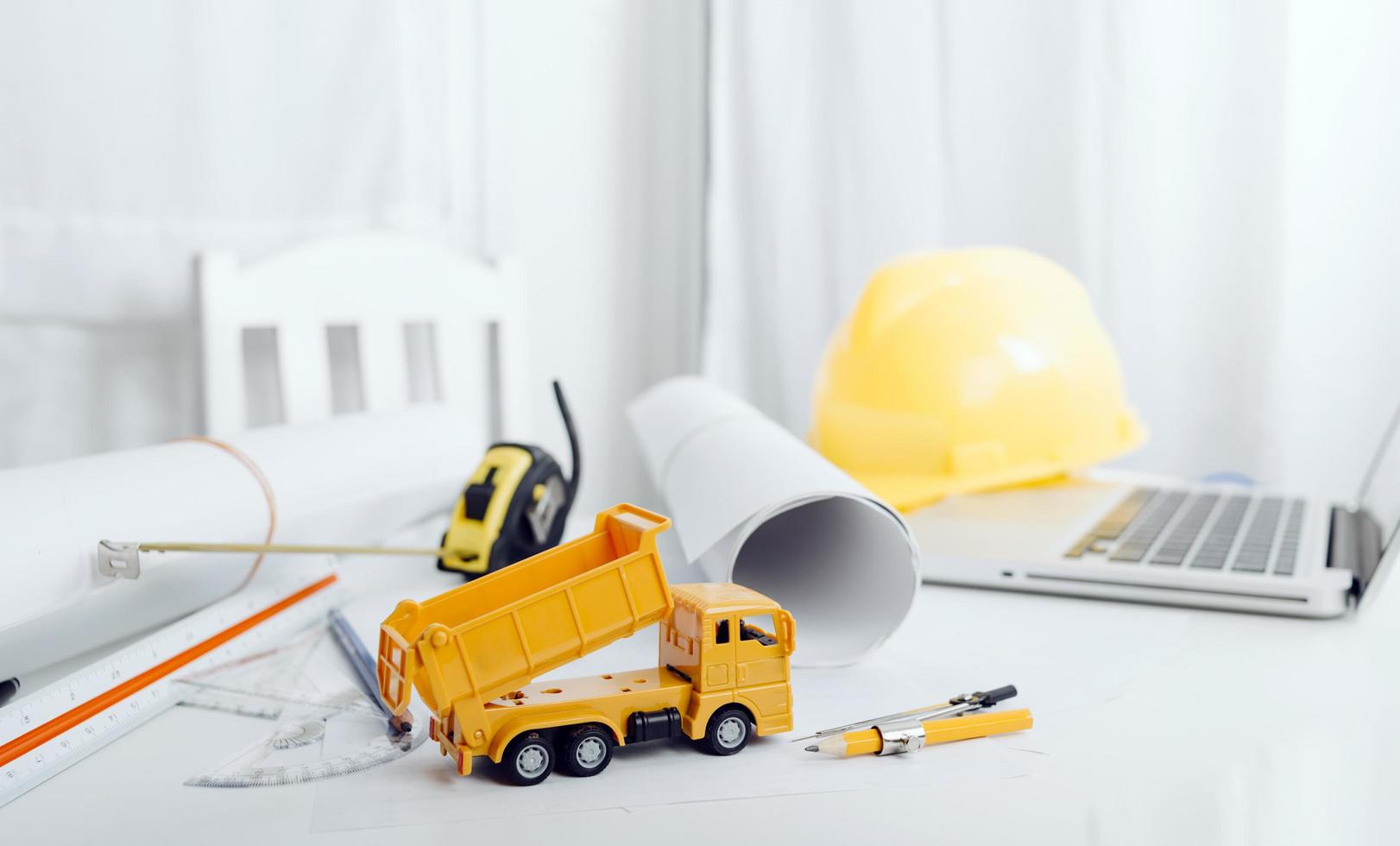 business hand working and laptop with on on architectural project at construction site at office desk in office photo