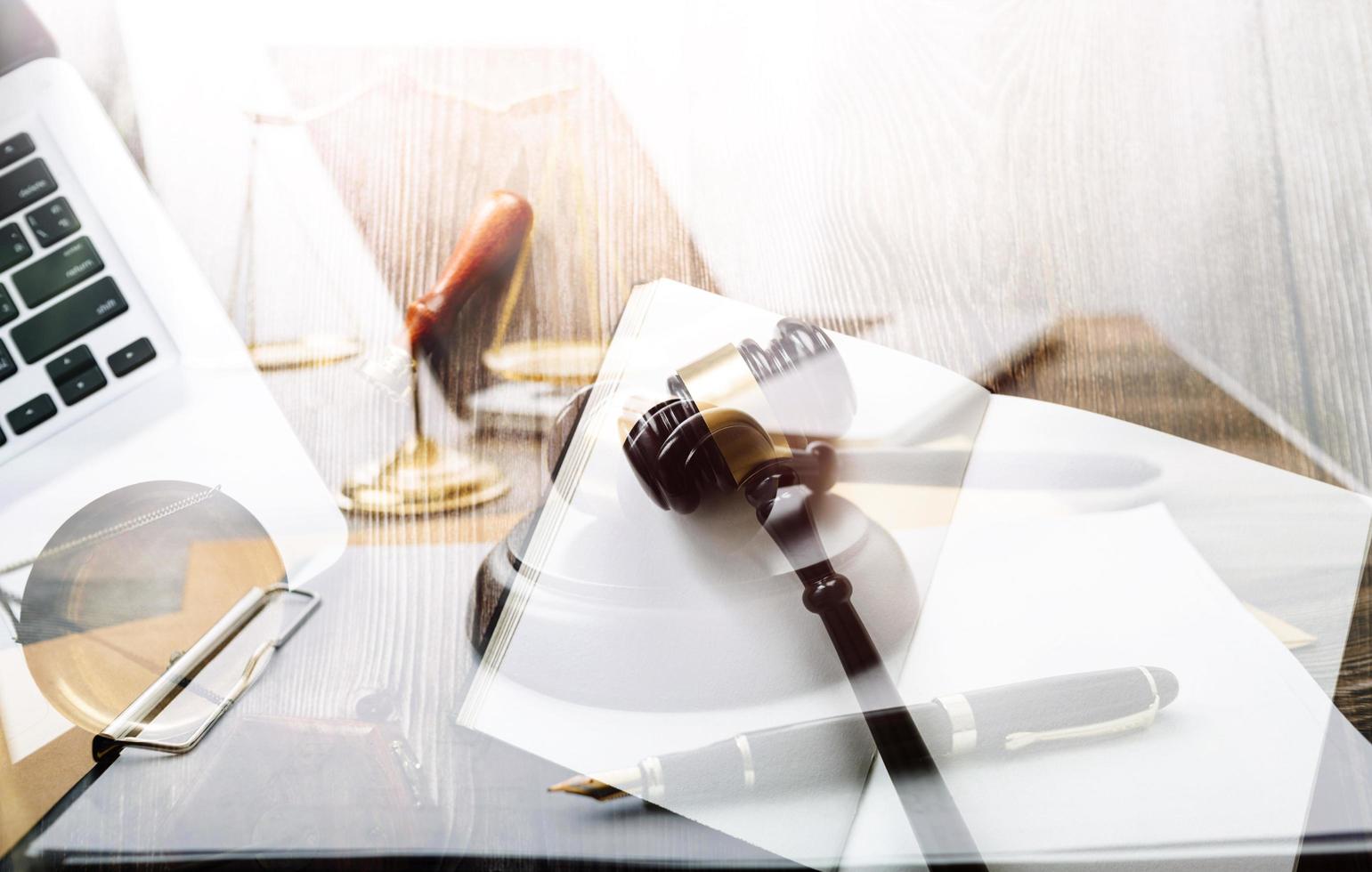 Justice and law concept.Male judge in a courtroom with the gavel, working with, computer and docking keyboard, eyeglasses, on table in morning light photo