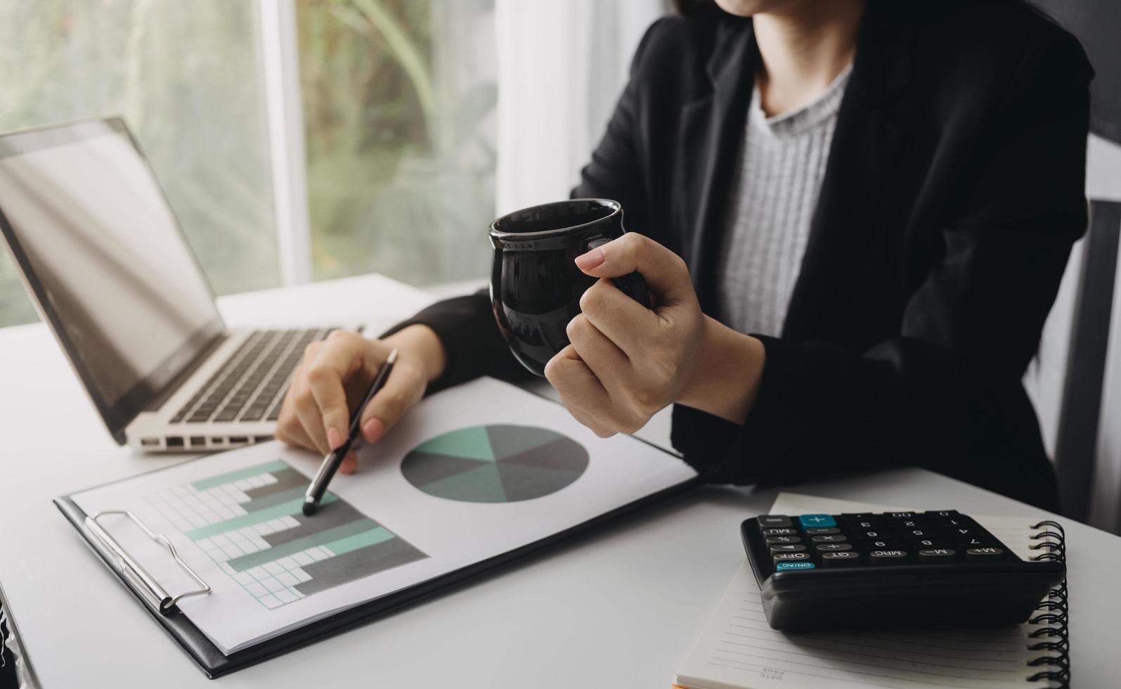 Business accounting concept, Business man using calculator with computer laptop, budget and loan paper in office. photo
