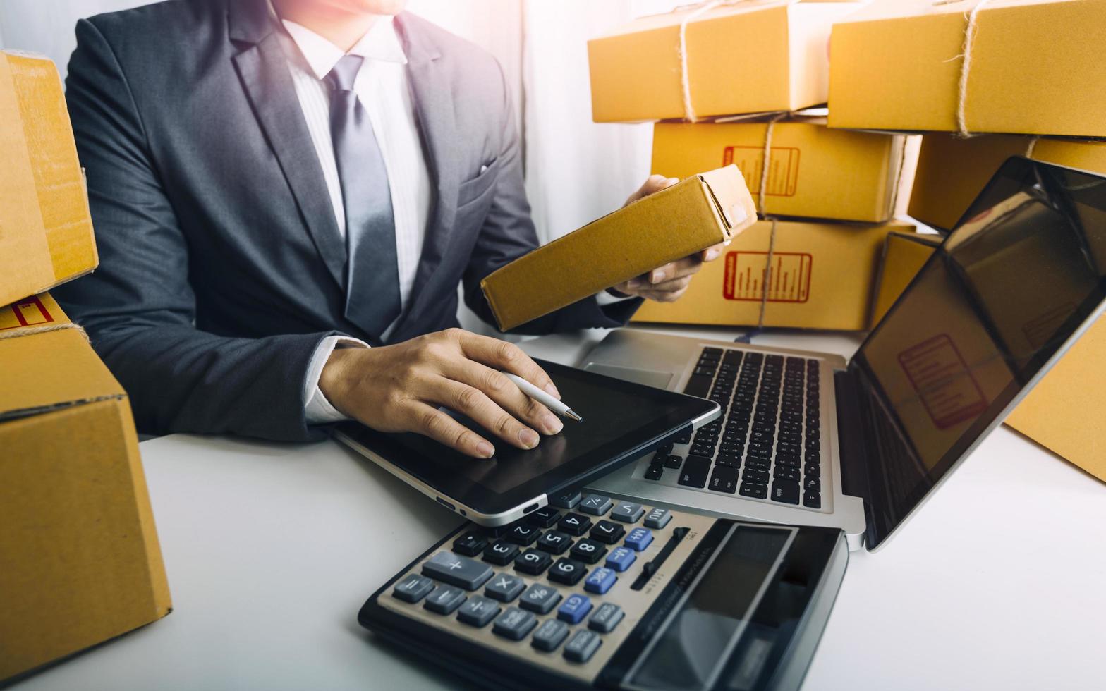 Business accounting concept, Business man using calculator with computer laptop, budget and loan paper in office. photo
