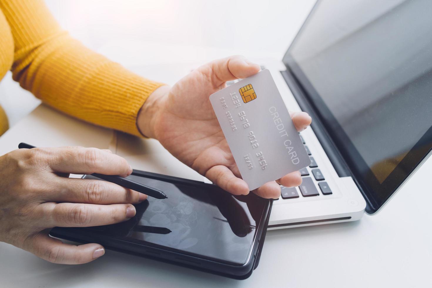 technology, people and online shopping concept - happy smiling man with tablet pc computer and credit card at home photo