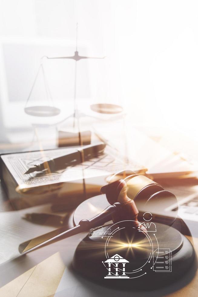 Justice and law concept.Male judge in a courtroom with the gavel, working with, computer and docking keyboard, eyeglasses, on table in morning light photo