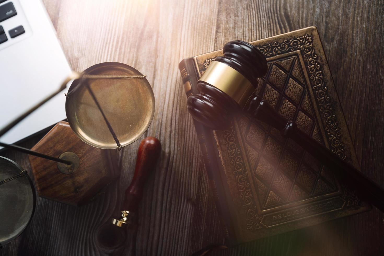 Business and lawyers discussing contract papers with brass scale on desk in office. Law, legal services, advice, justice and law concept picture with film grain effect photo