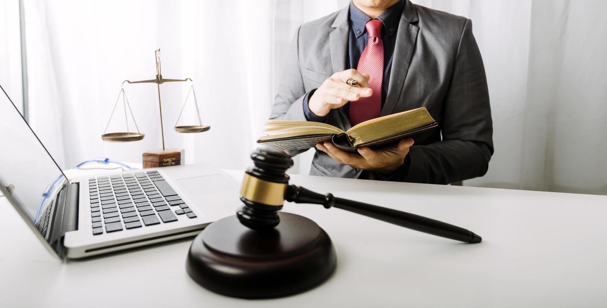 Business and lawyers discussing contract papers with brass scale on desk in office. Law, legal services, advice, justice and law concept picture with film grain effect photo