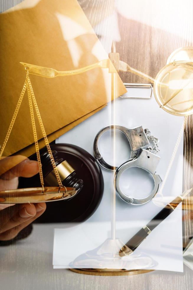 Business and lawyers discussing contract papers with brass scale on desk in office. Law, legal services, advice, justice and law concept picture with film grain effect photo