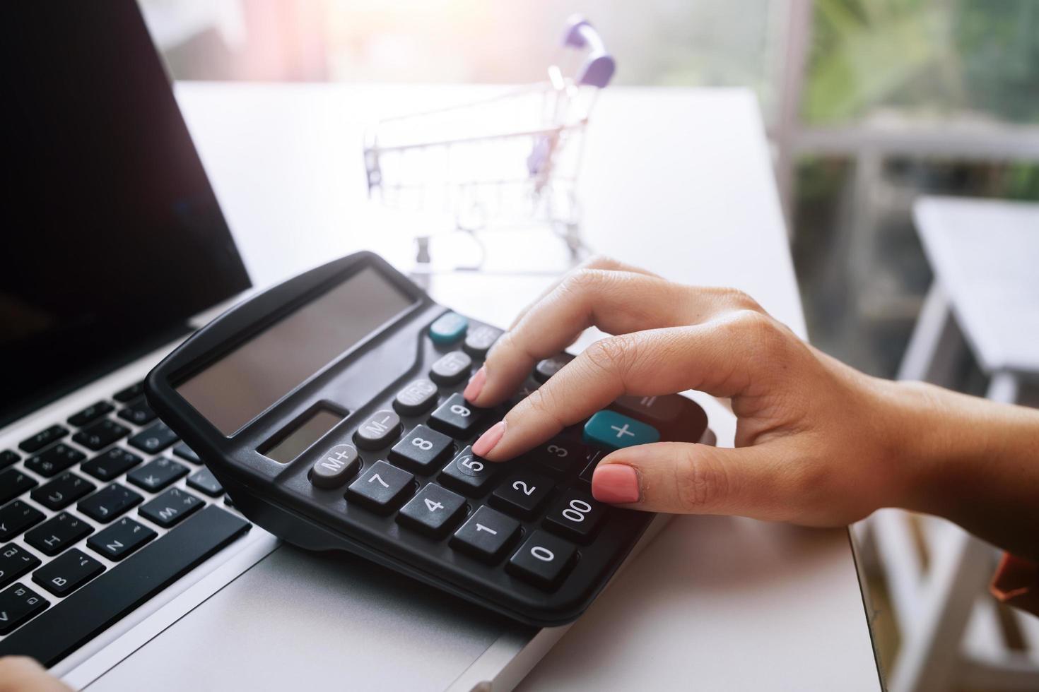 Business accounting concept, Business man using calculator with computer laptop, budget and loan paper in office. photo