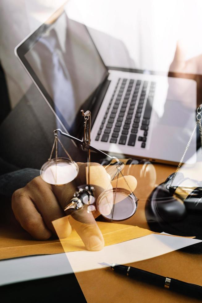 Business and lawyers discussing contract papers with brass scale on desk in office. Law, legal services, advice, justice and law concept picture with film grain effect photo