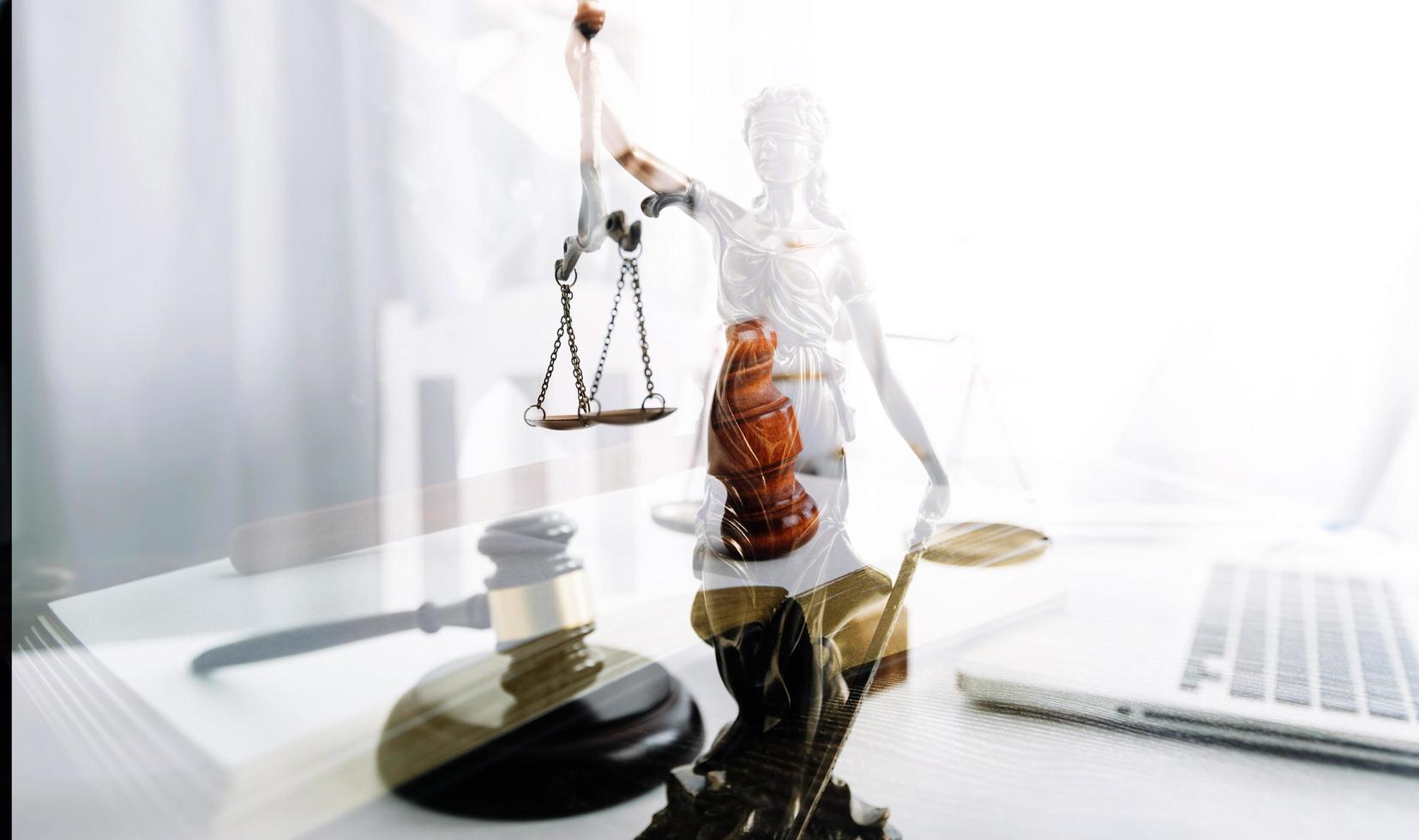 Justice and law concept.Male judge in a courtroom with the gavel, working with, computer and docking keyboard, eyeglasses, on table in morning light photo