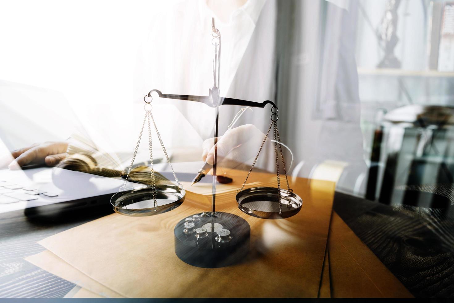 Business and lawyers discussing contract papers with brass scale on desk in office. Law, legal services, advice, justice and law concept picture with film grain effect photo