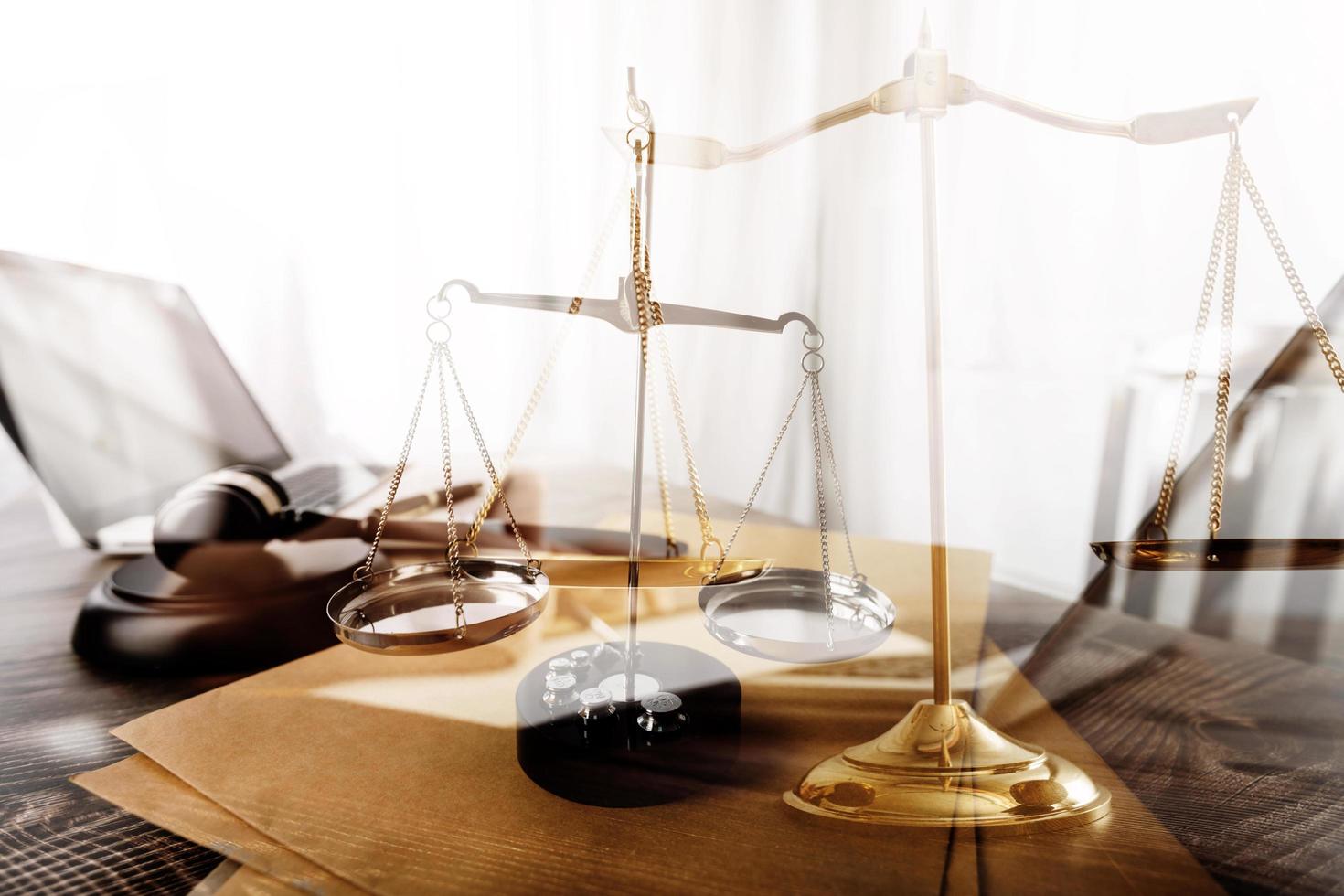 Business and lawyers discussing contract papers with brass scale on desk in office. Law, legal services, advice, justice and law concept picture with film grain effect photo