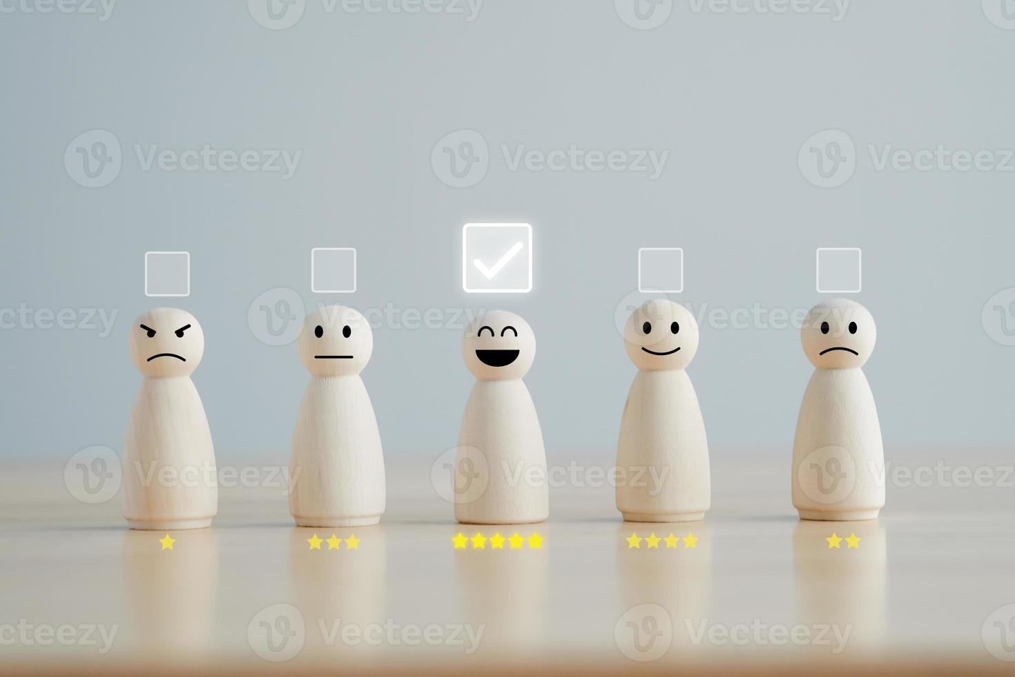 Select happy face wooden figure with 5 star. Customer service rating experience and feedback emotion and satisfaction survey. Human Resources management choosing positive attitude to team. photo