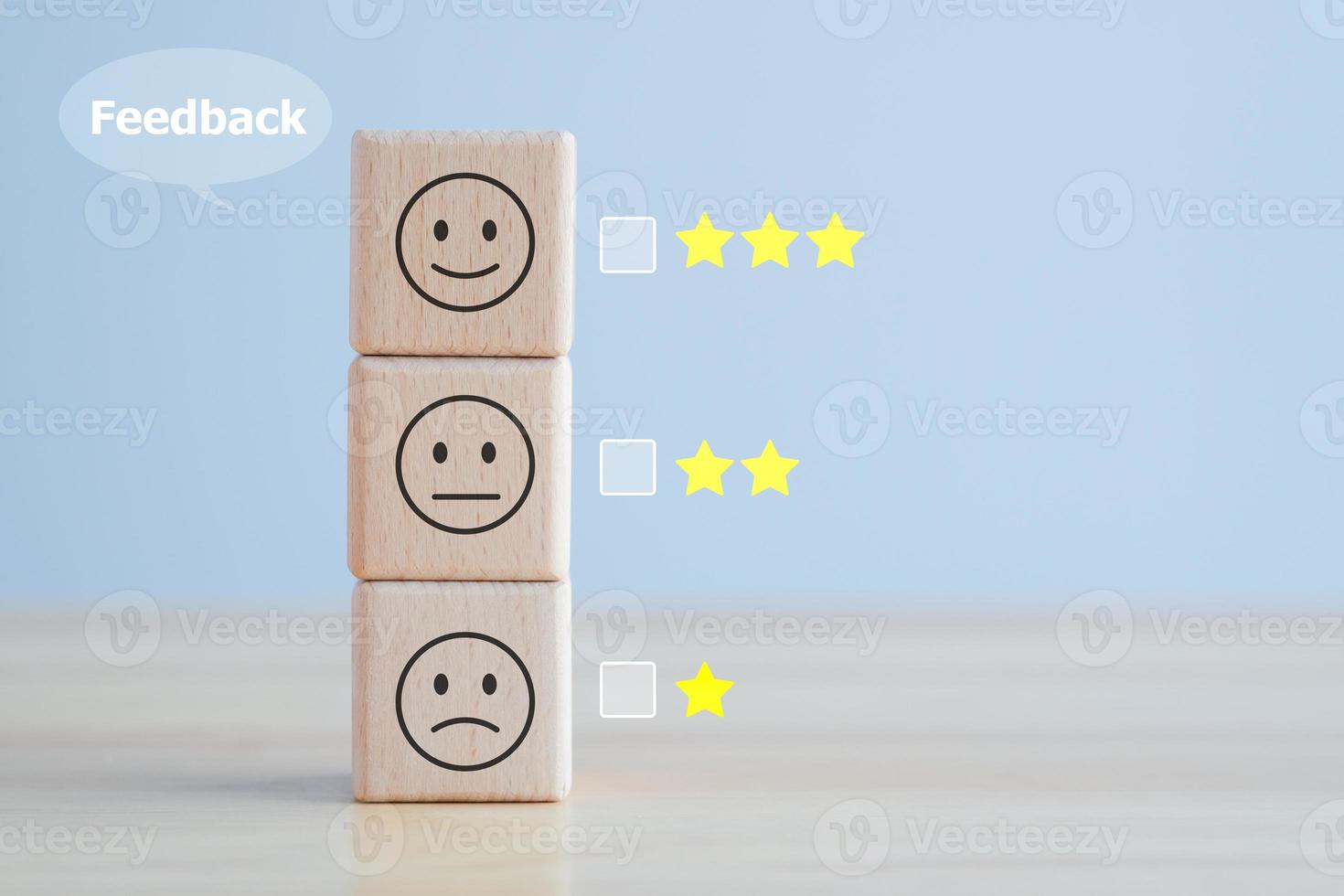 Business or customer service rating experience and feedback emotion and satisfaction survey concept. wood cube. satisfaction survey with star and negative, neutral and positive facial expressions. photo