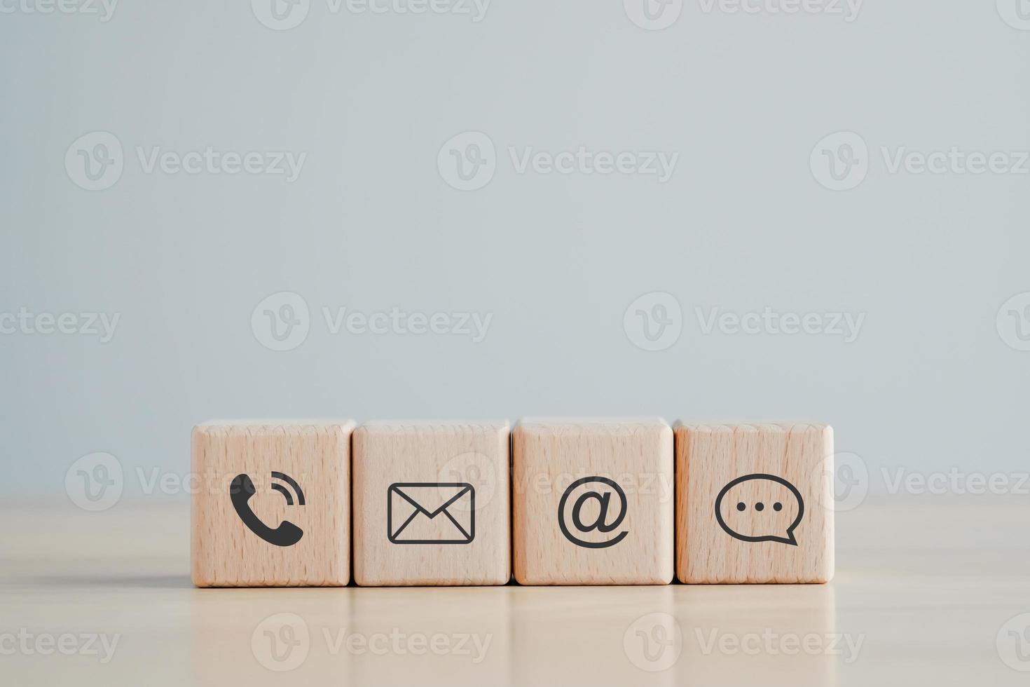 Website page contact us or e-mail marketing concept, Customer support hotline Contact us people connection. phone, email, address and chat message icon on wooden blocks photo