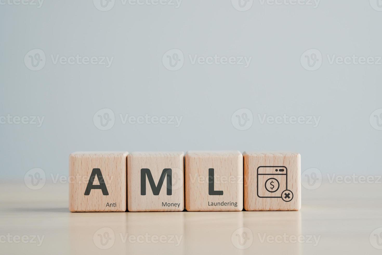 AML - Anti Money Laundering concept. Financial Bank Business. Against Illegal Earnings and corruption. Wooden block with AML text and dollar coin in washing machine. photo