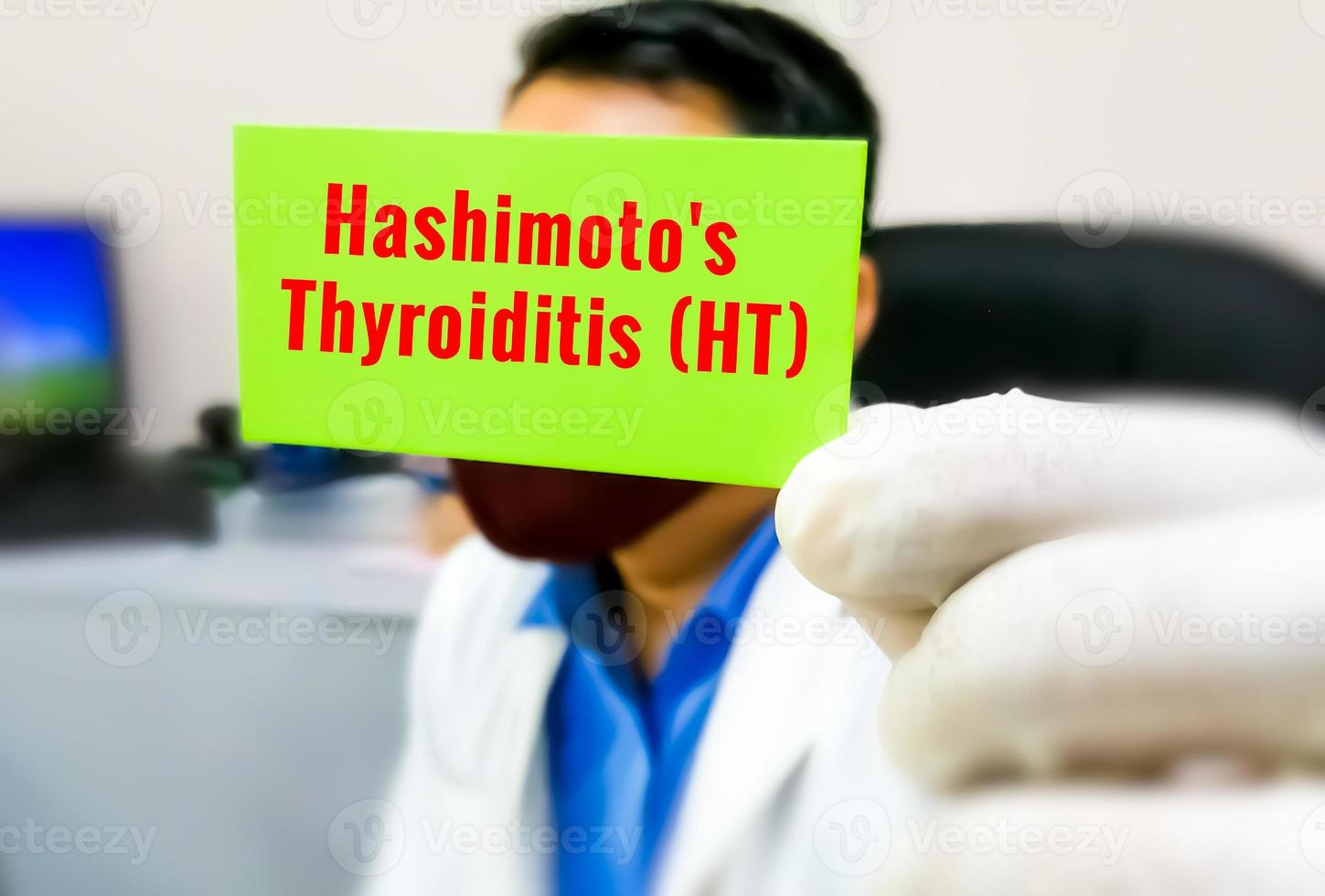 Hashimoto's Thyroiditis word on a card in doctor's hand, medical term word with medical concepts. photo