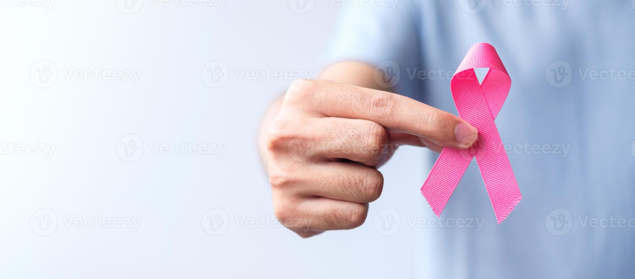 Pink October Breast Cancer Awareness month, man hold pink Ribbon for support people life and illness. National cancer survivors month, Mother and World cancer day concept photo