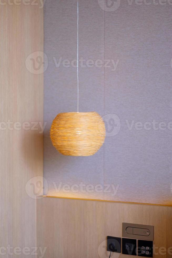Bamboo lamp hanging in bedroom. Scandinavian, minimal and bohemian style photo