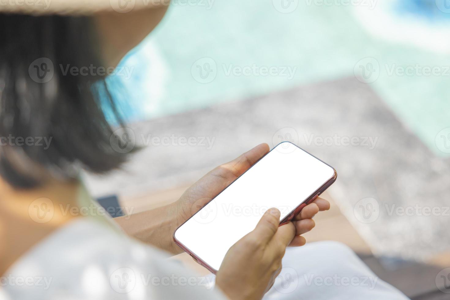 Close-up woman of Left hand held, right hand use finger touches with digital smartphone white screen isolated on white background. Concept of technology, connection, communication, social. photo